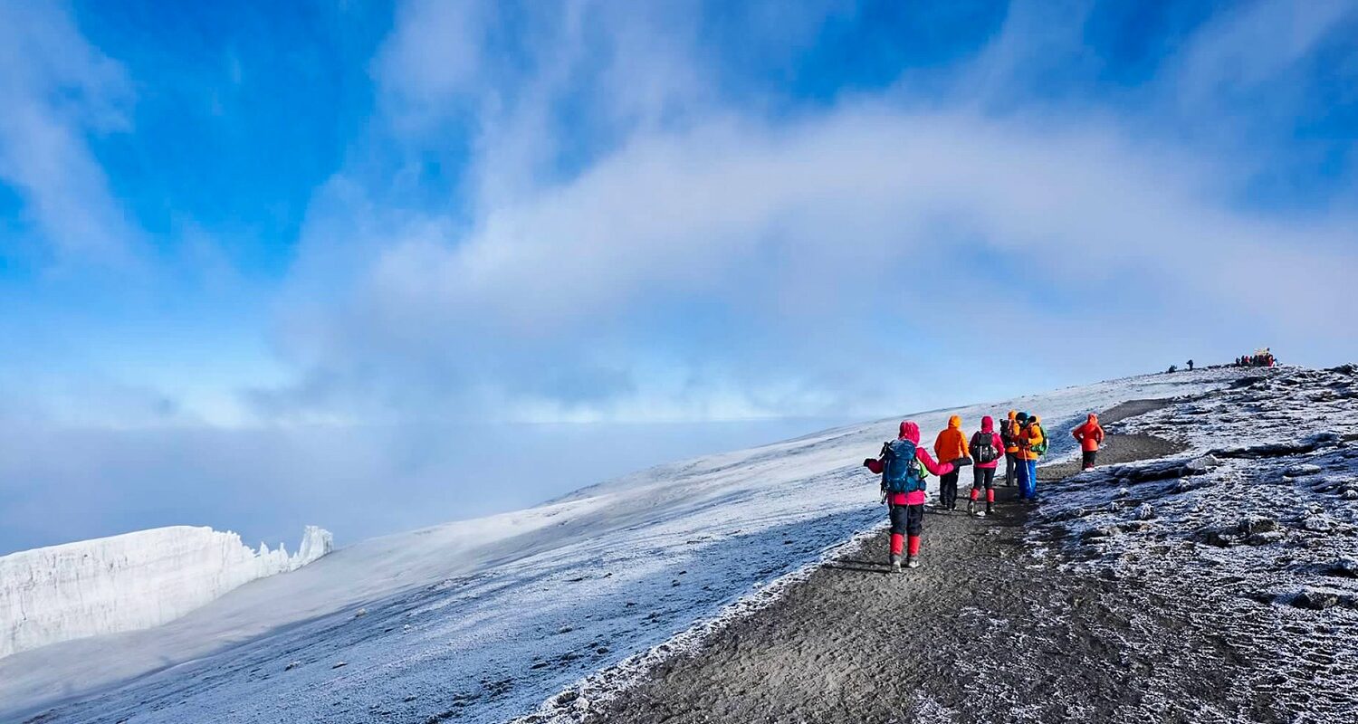 a group of people standing on top of a snow covered slope