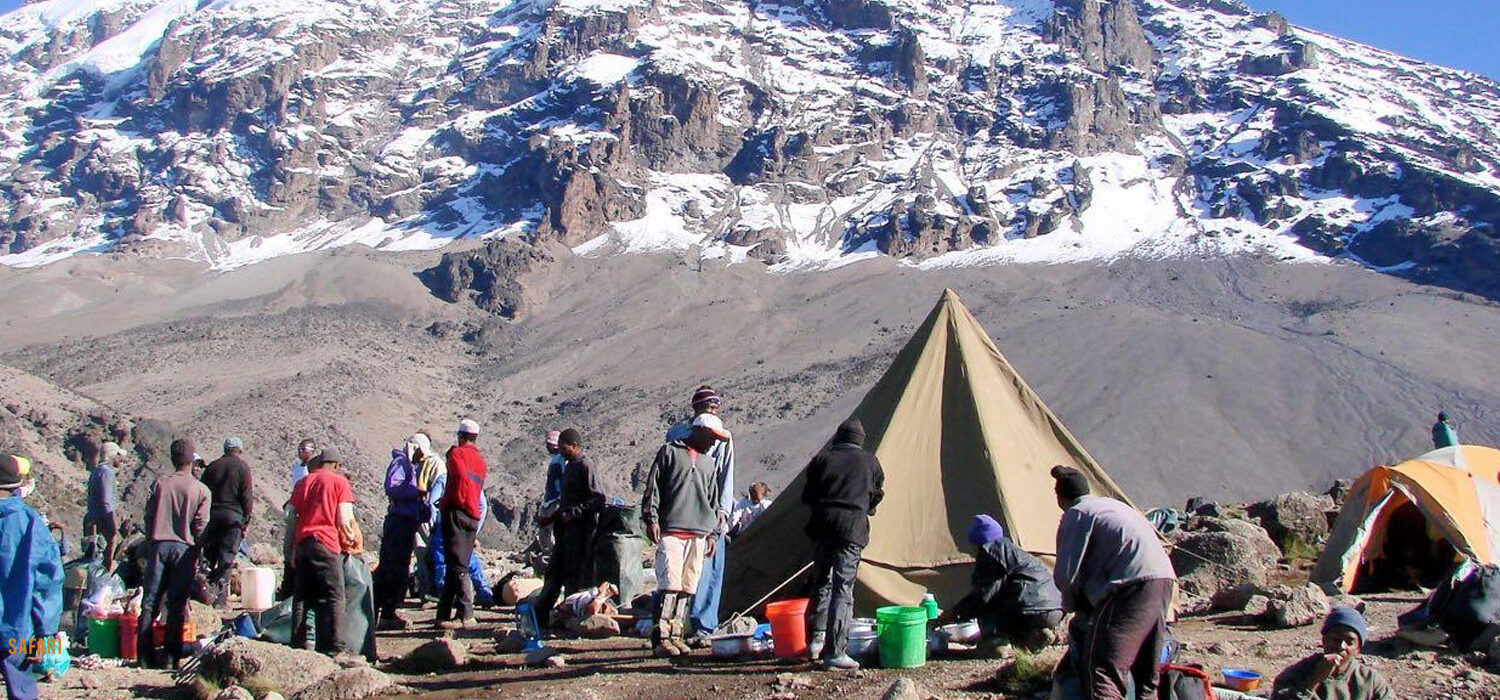 a group of people standing in front of a mountain